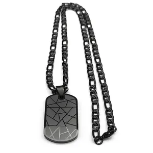 Close-up of matte black military dog tag with geometric lines and Figaro chain