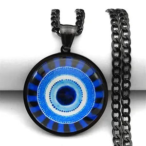 Macro detail of Evil Eye pendant with blue concentric circles on a black Cuban chain