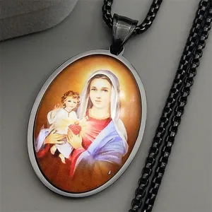 Detail of black metal necklace with religious oval pendant featuring Mary and Jesus