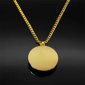 Detailed view of polished gold round pendant on thick stainless steel curb chain