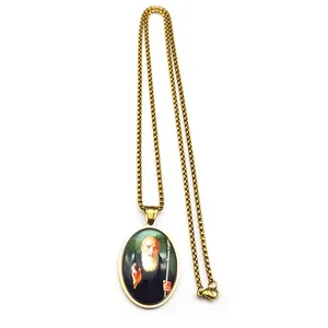 Detailed macro view of the gold oval Saint Benedict religious pendant with box chain