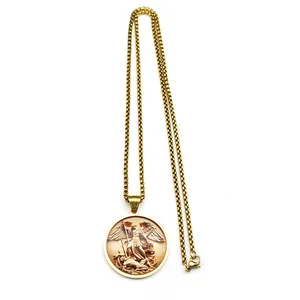 Detailed view of Saint Michael medallion pendant on a golden box chain necklace