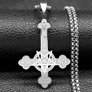 Macro detail of silver gothic inverted cross pendant with pentagram and floral textures