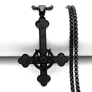 Macro detail of black gothic inverted cross necklace with pentagram and ornate engraving
