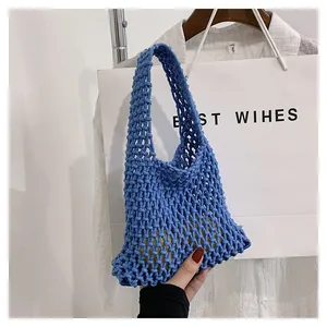 Close-up of blue handmade woven mesh bag with diamond pattern and single handle