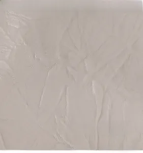 Detailed macro view of soft light grey leather texture with natural folds on shoulder bag