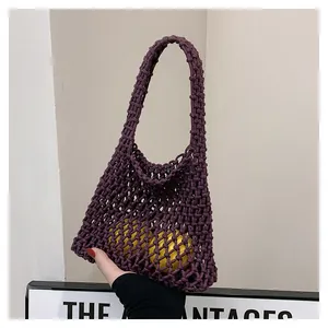 Detail of purple handmade crochet tote bag featuring thick woven mesh and lemon accents
