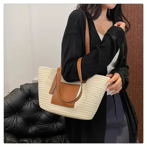 Lifestyle shot of large woven tote bag with brown leather straps and cream texture