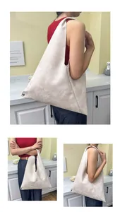Detail of minimalist cream marble pattern tote bag with triangular cutout handle
