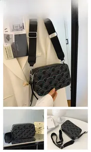 Close-up of black PU leather camera bag with rainbow arch embroidery and nylon strap