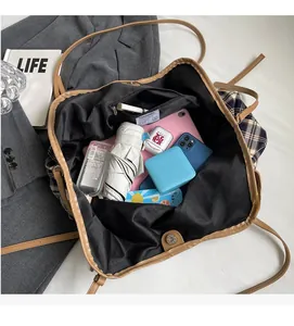 Spacious interior of plaid tote bag showing compartments and daily essentials