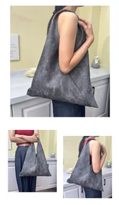 Close-up of the vintage textured grey tote bag featuring unique triangular design