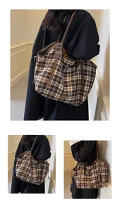 Macro detail of retro checkered tote bag featuring brown leather straps and side logo patch