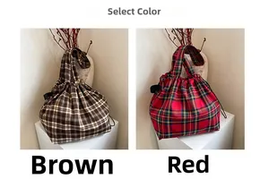 Detail view of vintage plaid tote bags in coffee and red colors with drawstring closure