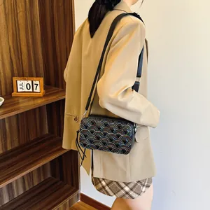 Chic black PU leather crossbody bag with colorful wavy embroidery and adjustable strap