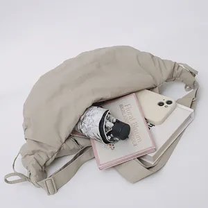 Large capacity beige dumpling crossbody bag with pleated nylon fabric for daily commuting