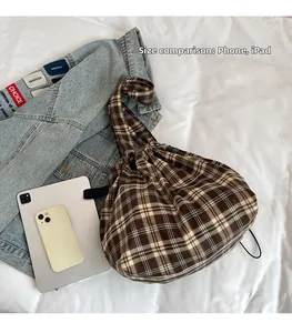 Detail view of large check pattern tote bag with phone and tablet for size comparison