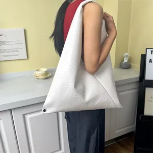 Minimalist white soft leather tote bag with pleated texture and shoulder strap design