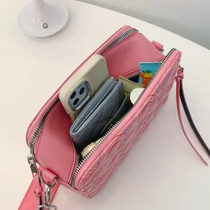 Pink quilted PU crossbody bag showing internal storage for phone and cosmetics