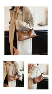 Détails d'un sac en cuir marron brillant avec rivets métalliques et tirette élégante