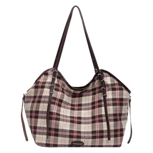 Pink checkered canvas tote bag with brown straps and spacious interior for daily use
