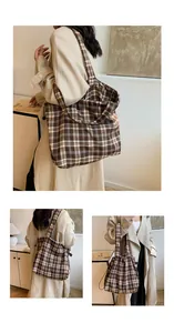 Detail of checkered bucket bag with drawstring closure and large capacity canvas straps