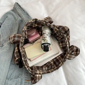 Retro plaid canvas tote bag with large capacity showing daily items like books and umbrella