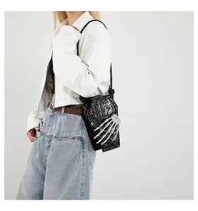 Detailed view of goth coffin bag featuring 3D skeleton hand and skull embossed texture