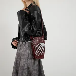 Gothic coffin crossbody bag with skull texture and skeleton hand chain detail