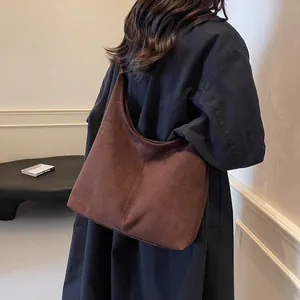 Brown large suede hobo shoulder bag with a minimalist vertical seam design for women