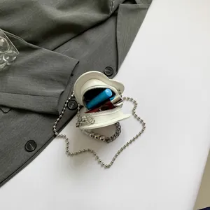 Modern white heart-shaped mini crossbody bag with silver chain straps and glossy finish