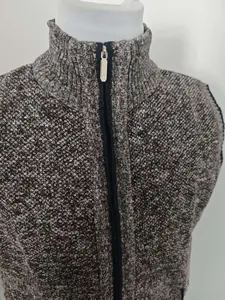 Detail of front zipper closure and stand collar on men's knitted texture vest