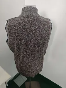Detail view of the back of a dark gray and brown mixed knit men's stand-up collar vest