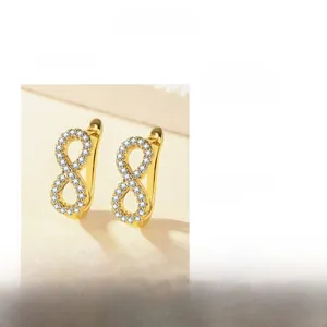 Detailed view of infinity-shaped gold earrings with dimensions 18.8mm by 7.4mm