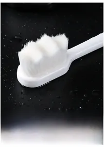 Macro shot of ultra-fine wavy soft bristles on a white nano toothbrush for gum care