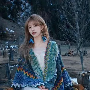 Detailed knit texture of colorful bohemian shawl with wavy patterns and jagged edges