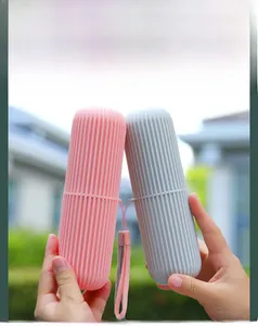 Detail of pink and grey travel toothbrush holders with vertical non-slip ridges and straps