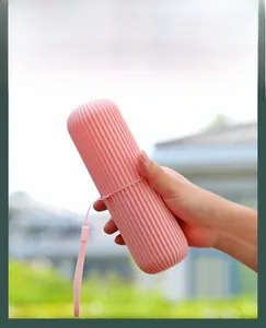Pink portable toothbrush storage case with anti-slip stripes and a handy carrying strap