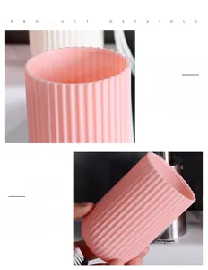 Detail of pink travel toothbrush cup with vertical anti-slip stripes and smooth round rim