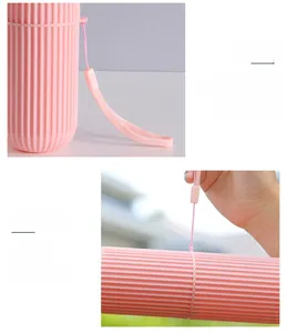 Pink travel toothbrush case with anti-slip stripes, sealing ring, and carry strap