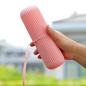 Portable pink travel toothbrush storage case with striped texture and carrying strap