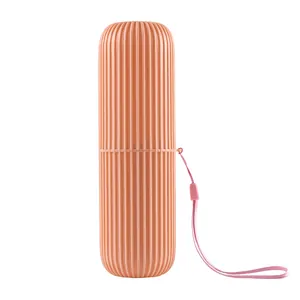 Portable travel toothbrush holder cup in coral pink with vertical non-slip texture