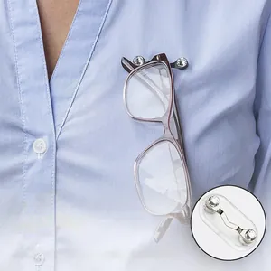 Detail of V-shaped magnetic glasses holder with rhinestones on a striped shirt