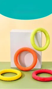 Macro view of colorful TPR foam dog training rings with anti-slip texture and branding