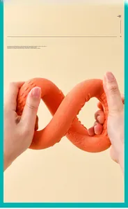 Close-up of flexible orange TPR dog toy being twisted to show soft high elasticity texture