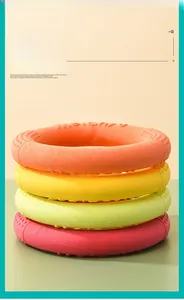 Close-up of four colorful TPR training rings for dogs with anti-slip texture and soft material
