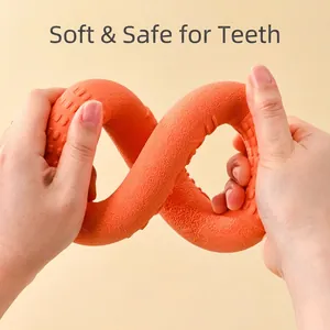 Flexible orange TPR dog chew ring being twisted to show its soft and durable texture