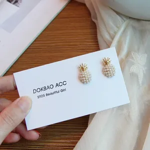 Macro shot of pineapple pearl earrings with S925 silver needles on display card