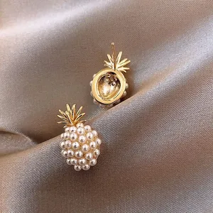 French vintage pineapple pearl stud earrings in gold metal on champagne silk