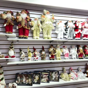 Assorted standing Santa Claus and gnome figurines on display shelves for Christmas decor